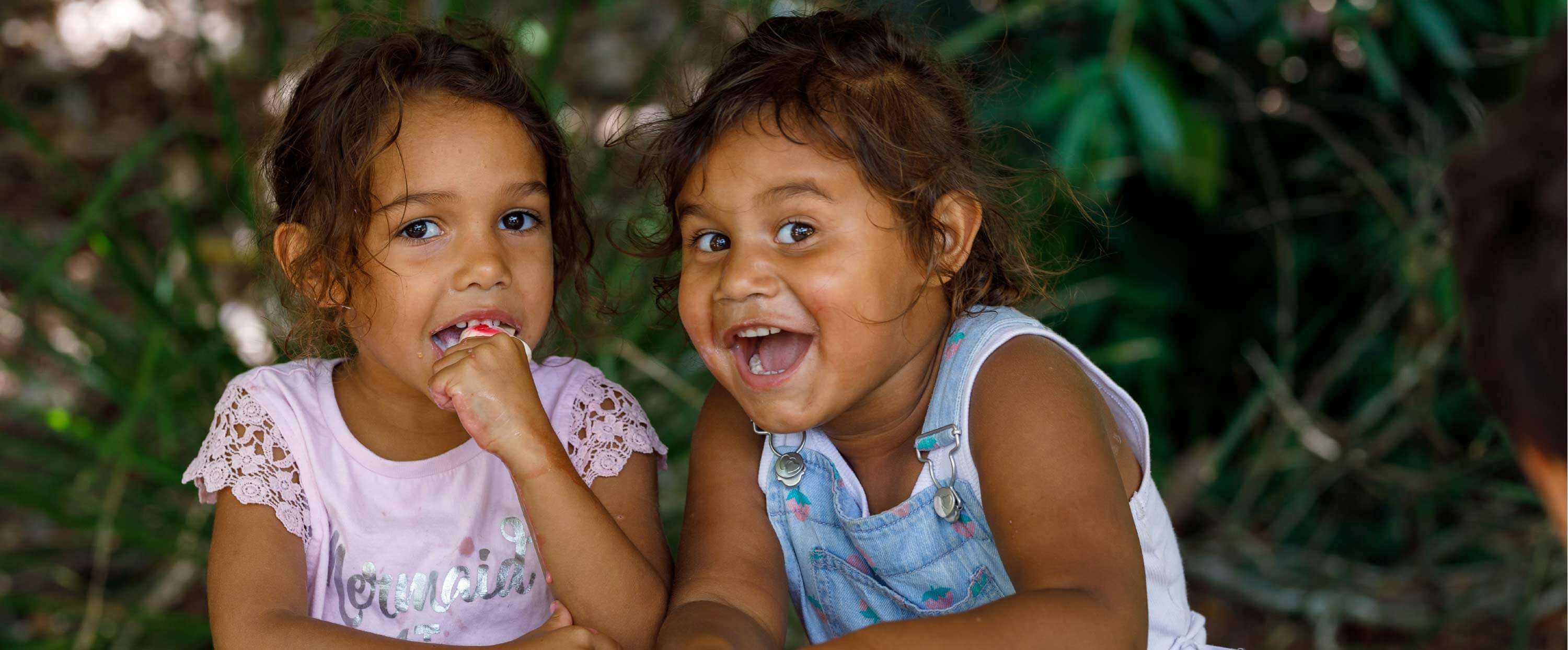 Two young aboriginal girls smiling