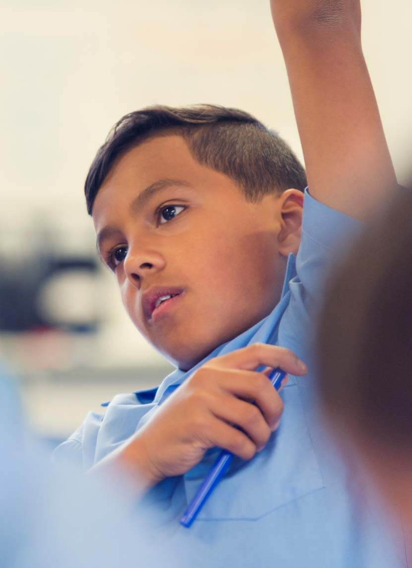 Young Aboriginal School Boy raising his hand